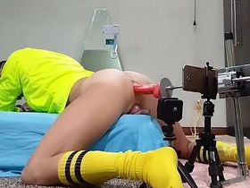 Asian lad's yellow artillery fires off in a wild gay assplay session. He gets his tight hole stretched by a massive dildo, riding it with abandon in a kinky buttmachine scene.