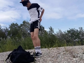 Cute twink Jon Arteen struts in black Adidas, flaunting underwear-free assets. He saunters freely, stroking through shorts, climaxing outdoors. A nature-bound, youthful freeball adventure.