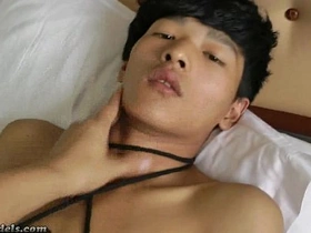 Tall, well-endowed Asian lads find themselves in a kinky scenario. Bound and helpless, they rely on each other for relief, their skilled hands working magic on their throbbing members, creating an electrifying bondage bonding session.