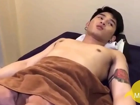A tantalizing Asian twink, eager to please, delicately caresses his partner's sensitive balls. His skilled hands work magic, igniting passion and desire in this steamy gay encounter.