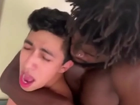 A muscular black hunk dominates an eager Asian twink, delivering intense pleasure. The tight ass and loud moans create an intoxicating rhythm as they explore their desires.