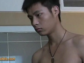 A slender Asian twink with a smooth body indulges in self-pleasure, showcasing his lean physique and delicate features. His moans and rhythmic movements lead to a climactic moment.