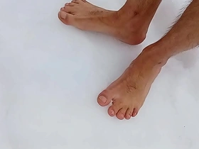 Barefoot in the snow, a seductive Asian beauty indulges in her fetish for snowy coldness on her delicate toes. Her toes wiggle in the chill, creating an enticing visual and sensory feast for those who appreciate such fetishes.