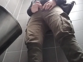 Young man with uncut dick peeing in a public urinal. he then shows and shakes his dick.