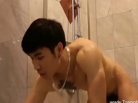 A muscled Asian jock dominates his partner, stroking his big cock with strong hands before climaxing. This Taiwanese gay handjob video showcases a handsome, muscular hunk enjoying a steamy session.